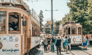 Image of trams in Porto with crowds waiting to embark, Portugal Work Visa | getNif 