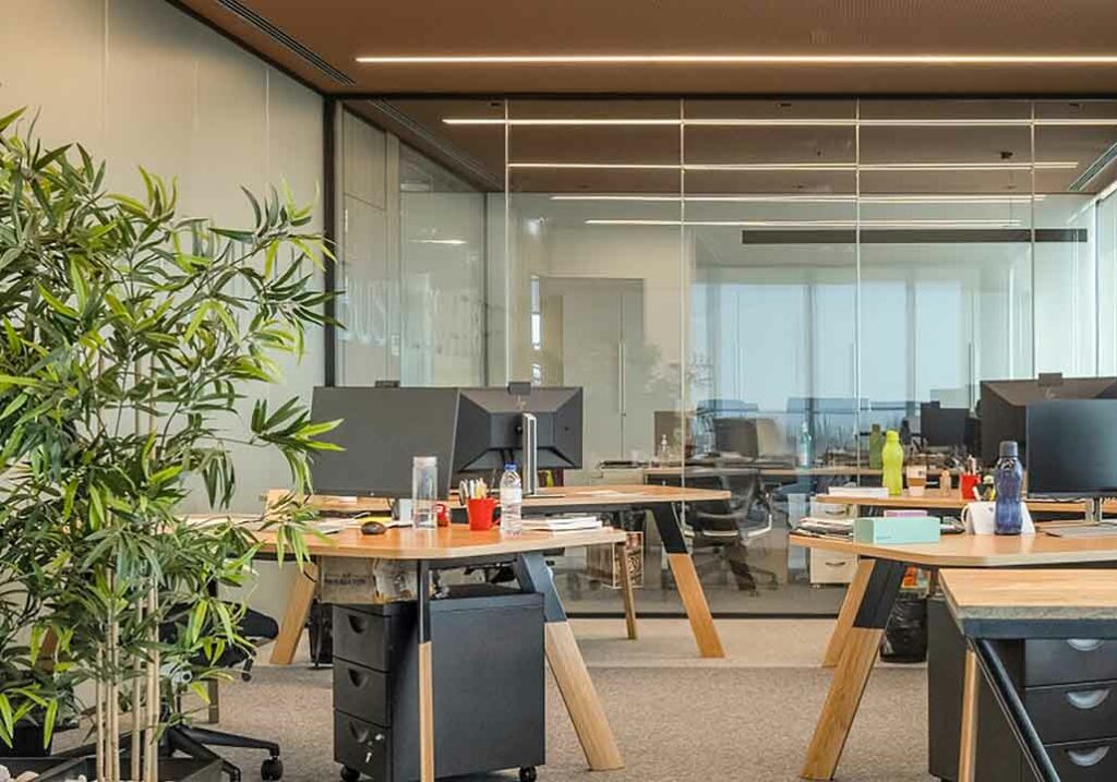 Portugal work visa, Image of portuguese office with rows of seats and tables and green plant in left corner, working in Portugal |GetNif