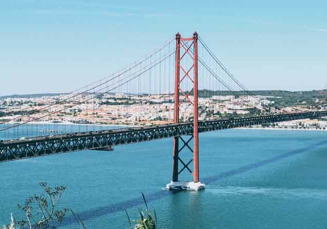 Image of April 25 bridge in Lisbon, water underneath the bridge. Portuguese citizenship requirements | GetNif