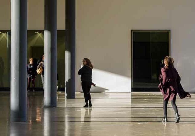 teachers walking in a school courtyard like environment being held up by three grey beams, International school teachers Portugal | GetNif
