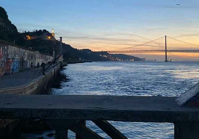 Image of sunset over Portuguese April 25 bridge, taken from Cacilhas port. Portuguese citizenship | GetNif