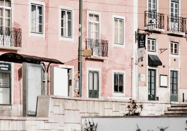 Image of pink Portuguese buildings, three blocks of flats in a row with balconies | Portugal visa options, GetNif