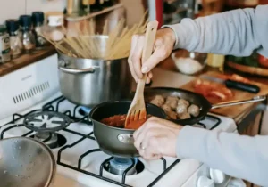 person cooking using gas